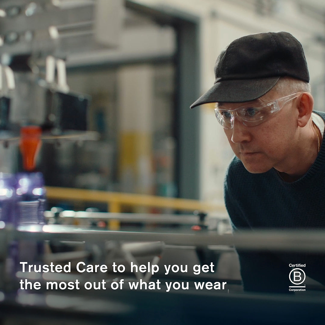 Founder of Jason Markk wearing safety glasses and a cap in a factory with text about trusted care.